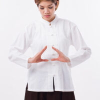 peaceful, strong, confident asian woman practice kungfu qigong, solar plexus concentration
